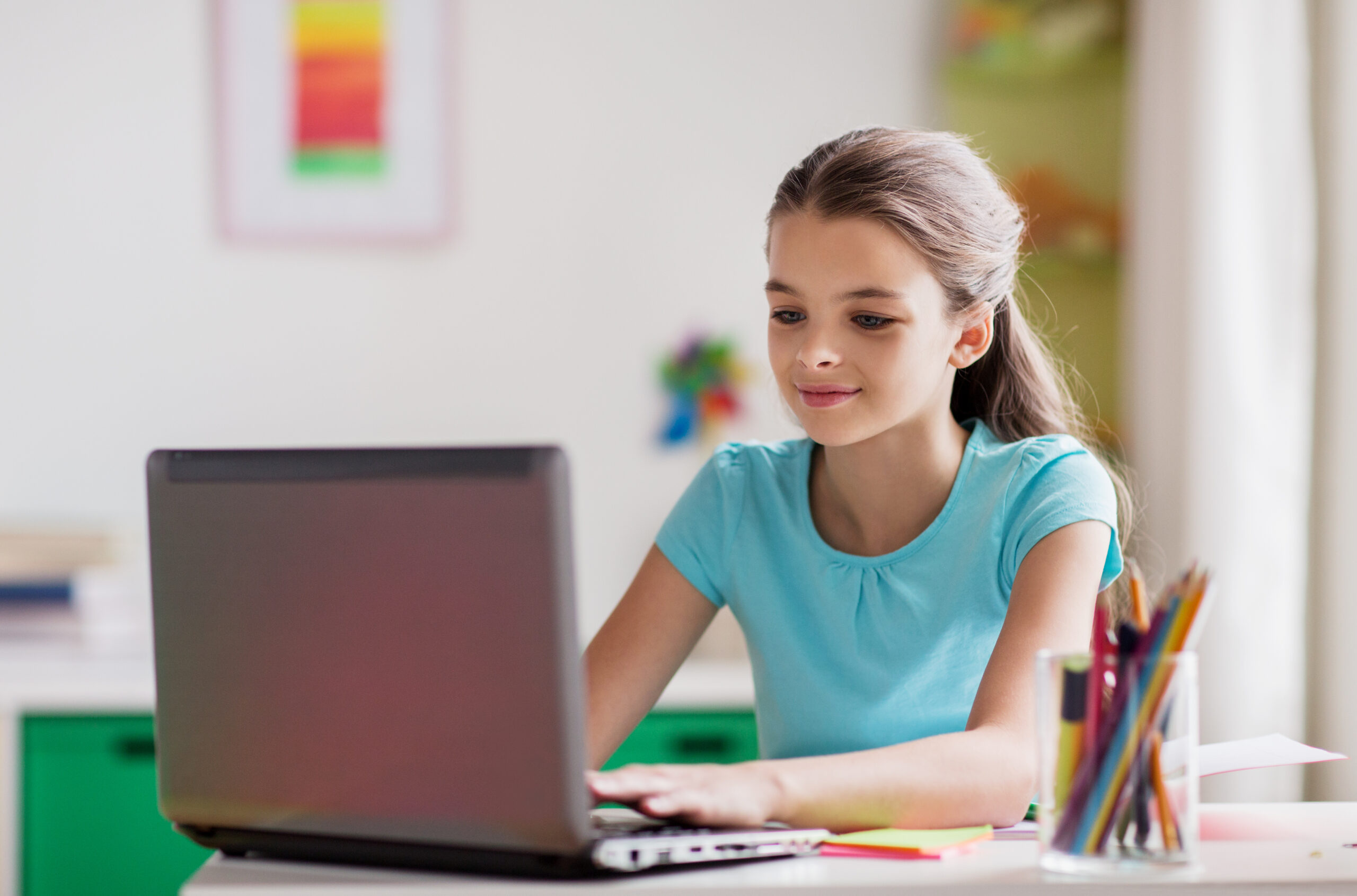 girl typing on laptop at home